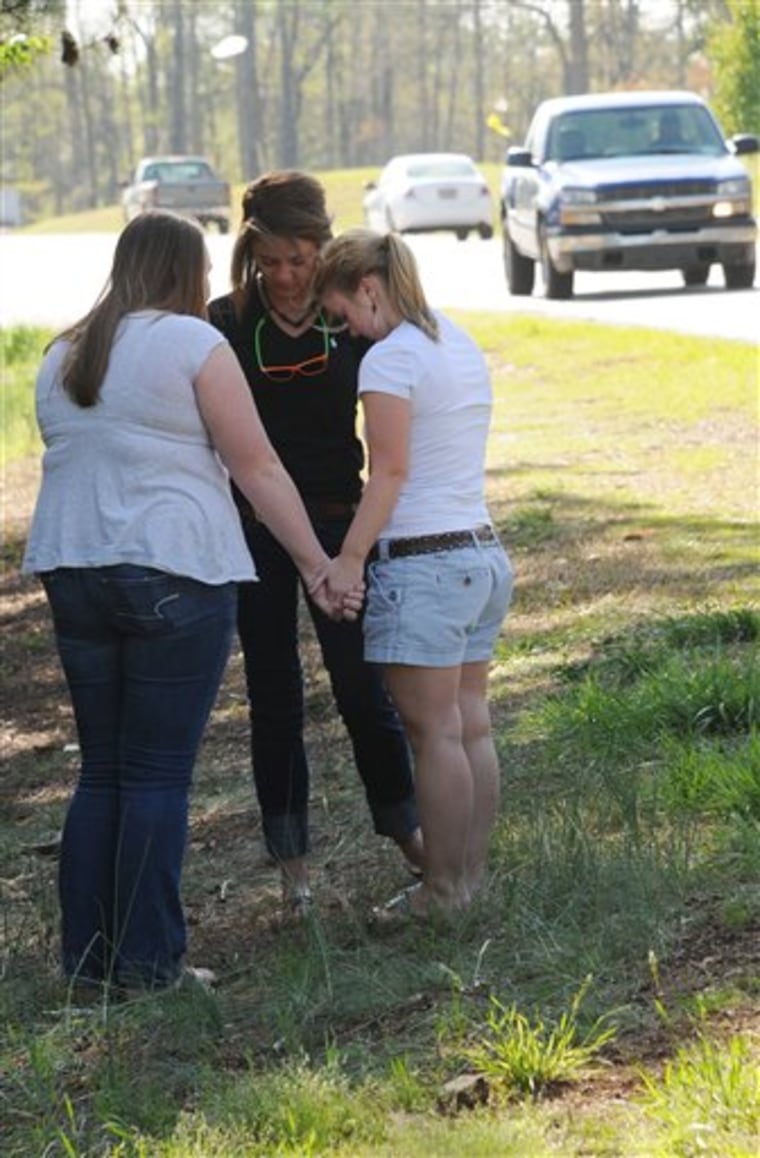 Friends of Aaron Shawn Hill pray Friday near where he was killed on Highway 129 in Duncan, S.C.